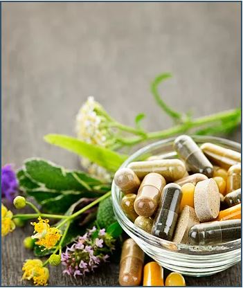 Picture of a few herbs and pills filled with material of different types illustrating components of a naturopathic medicine treatment